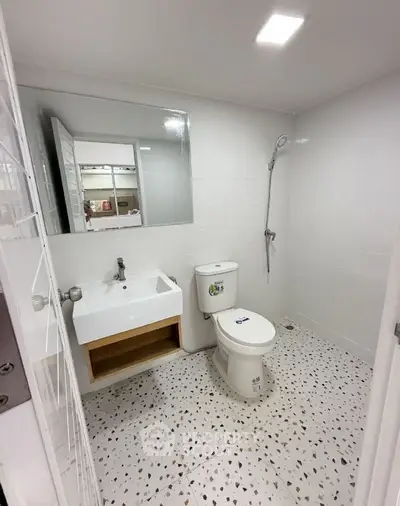Modern bathroom with sleek fixtures and terrazzo flooring