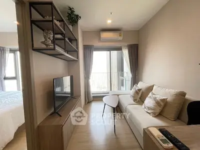 Modern living room with cozy sofa and TV, featuring a balcony view.