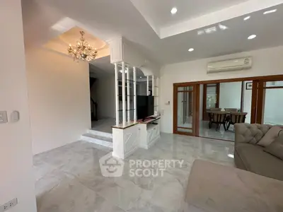 Spacious living room with elegant chandelier and modern design