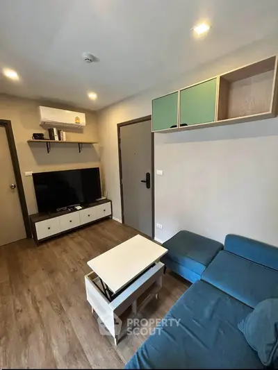 Modern living room with stylish furniture and entertainment center in a cozy apartment.