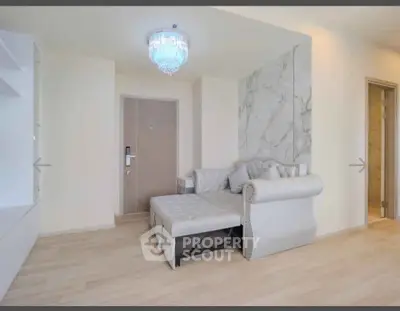 Elegant living room with luxurious sofa and modern chandelier in a stylish apartment.