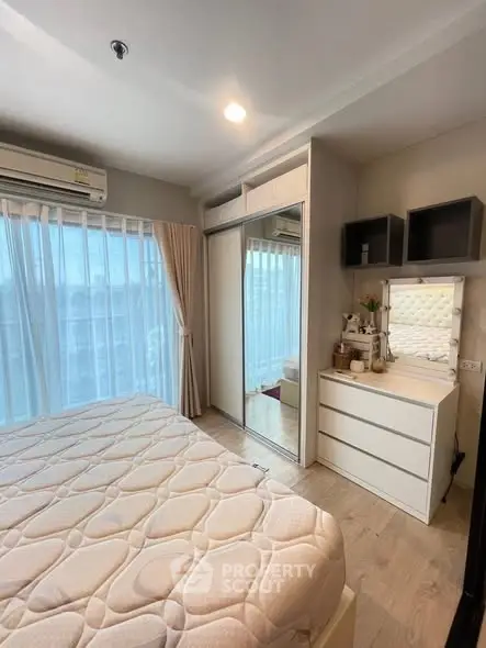 Cozy bedroom with mirrored wardrobe and natural light