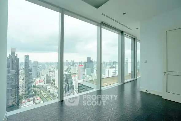 Luxurious high-rise apartment with stunning city view and floor-to-ceiling windows.