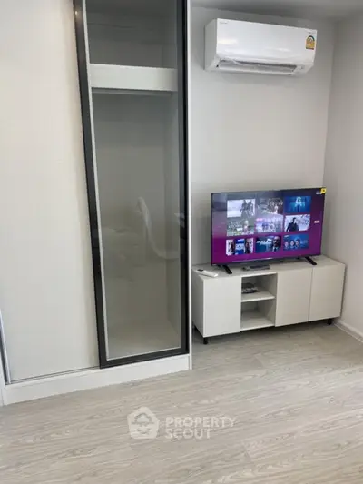 Modern living room with sleek TV unit and air conditioning