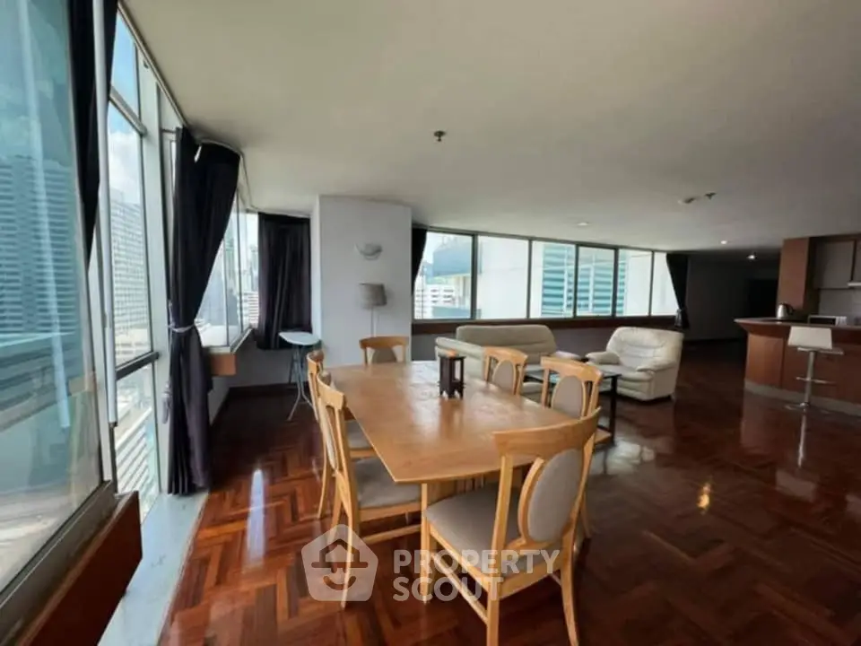 Spacious corner unit with big living room and city views, featuring elegant wooden flooring and modern furnishings.
