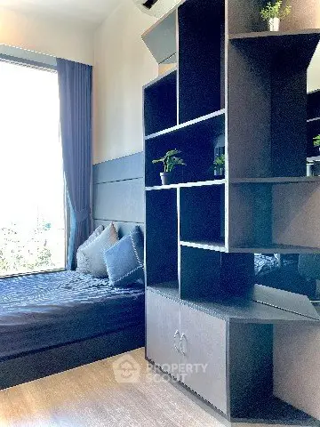 Modern bedroom with stylish shelving and large window view