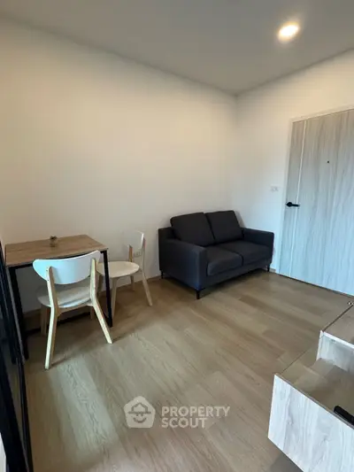 Cozy modern living room with wooden flooring and compact dining area