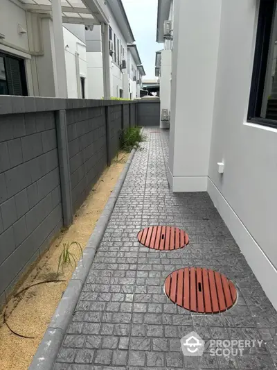 Modern residential pathway with stylish paving and sleek exterior design