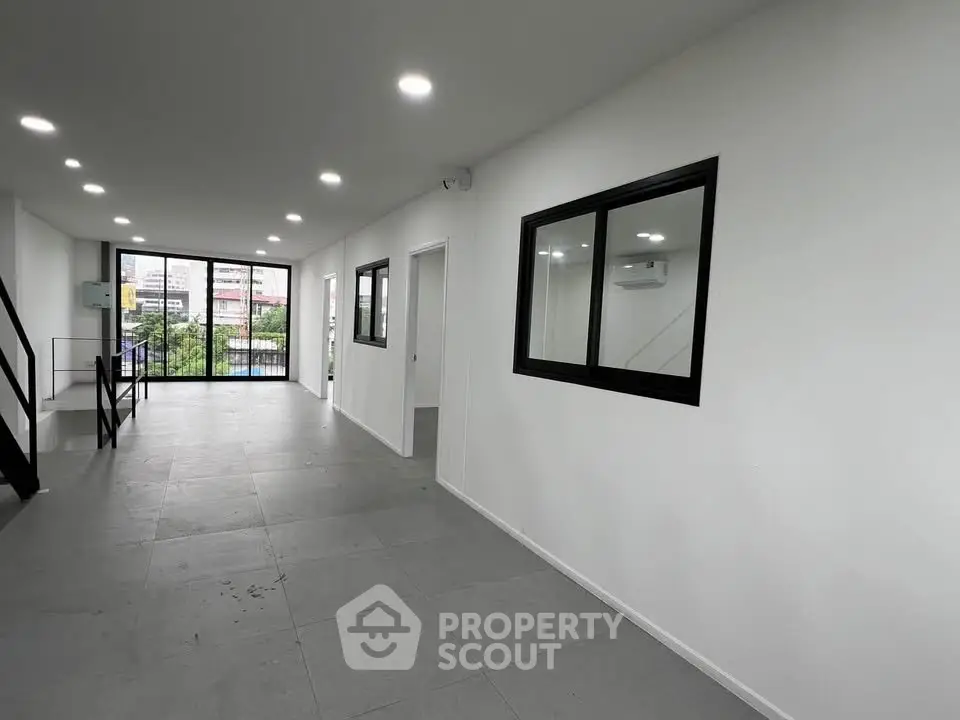 Spacious modern interior with large windows and sleek design, perfect for urban living.