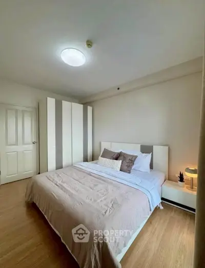 Cozy bedroom with modern decor and ample natural light
