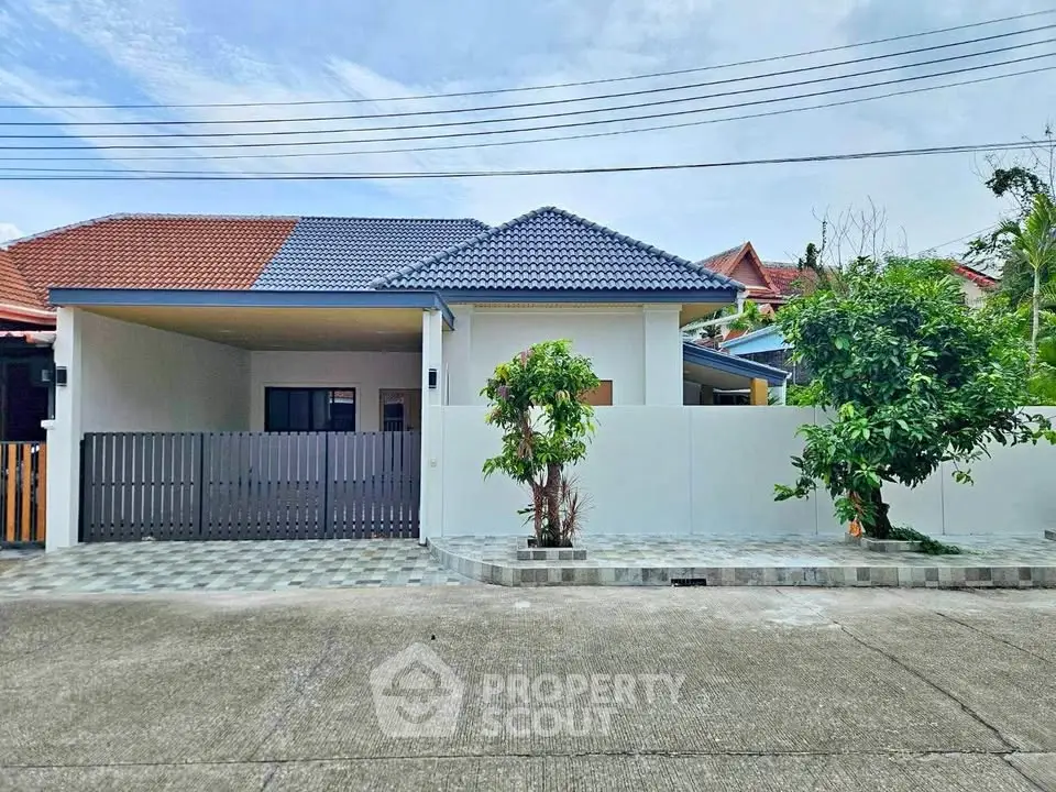 Charming single-story home with modern roof and spacious driveway in a serene neighborhood.