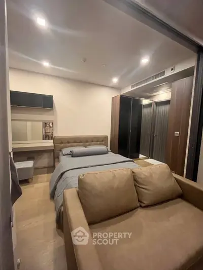 Modern bedroom with cozy sofa and stylish decor