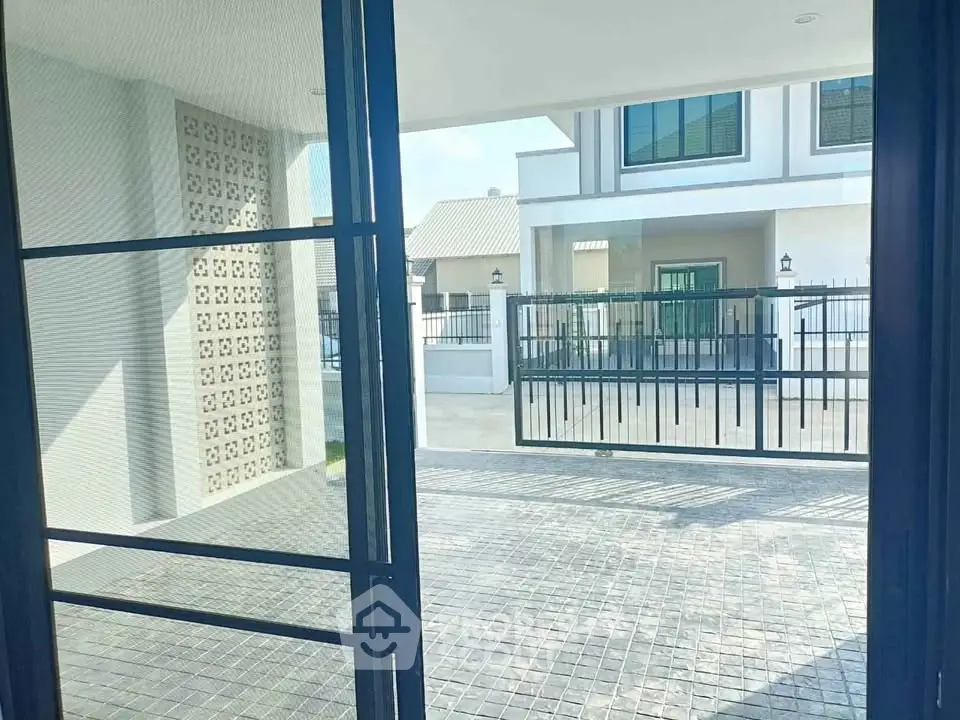 Modern house exterior with gated driveway and stylish facade