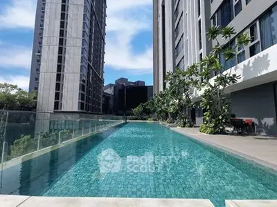 Luxurious high-rise apartment with stunning poolside view and modern architecture.
