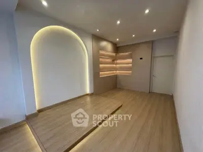 Modern minimalist room with wooden flooring and ambient lighting