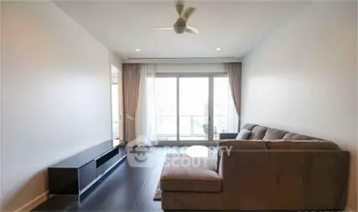 Modern living room with sleek furniture and large window for natural light.