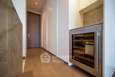 Modern kitchen with sleek wine cooler and elegant wooden flooring