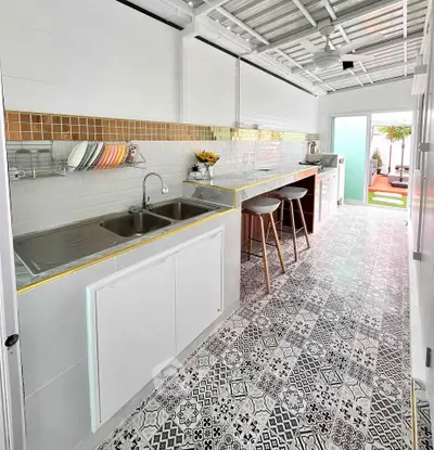 Chic kitchen with open layout and stylish tile flooring, perfect for modern living.