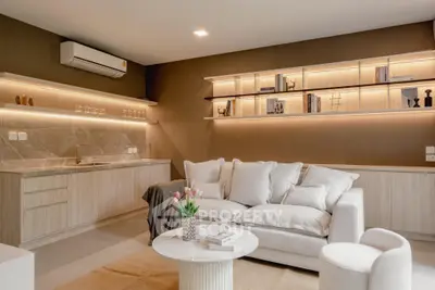 Luxurious living room with modern decor and elegant lighting, featuring a cozy sofa and stylish shelving.