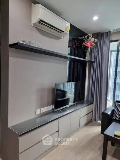 Modern living room with sleek TV unit and air conditioning