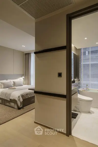Modern bedroom with ensuite bathroom featuring elegant design and neutral tones.