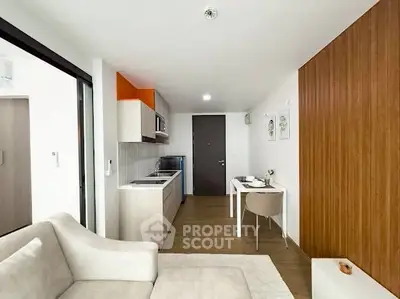 Modern open-plan living room with sleek kitchen and cozy dining area