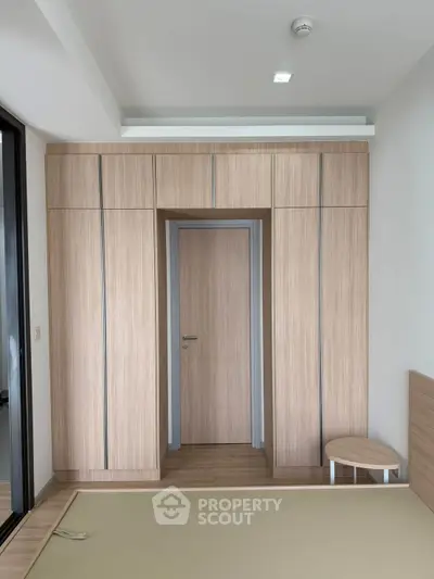 Modern bedroom with built-in wooden wardrobe and minimalist design