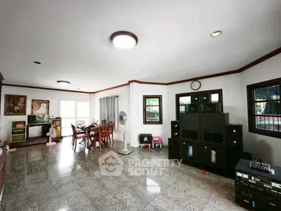 Spacious living room with modern decor and entertainment system, perfect for family gatherings.