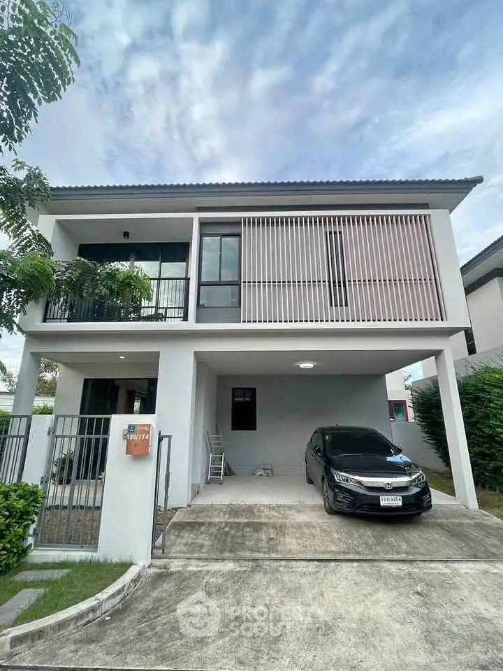 Modern two-story house with carport and sleek facade in suburban neighborhood.