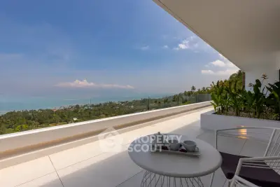 Stunning ocean view from a spacious balcony with modern seating and lush greenery.