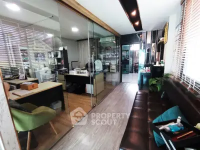 Modern office space with glass partitions and stylish furnishings