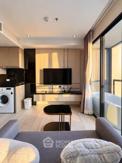 Modern living room with sleek design, featuring a large TV, washing machine, and floor-to-ceiling windows.