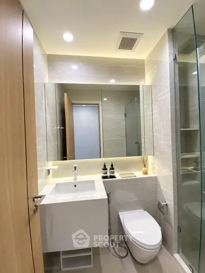 Modern bathroom with sleek fixtures and glass shower enclosure