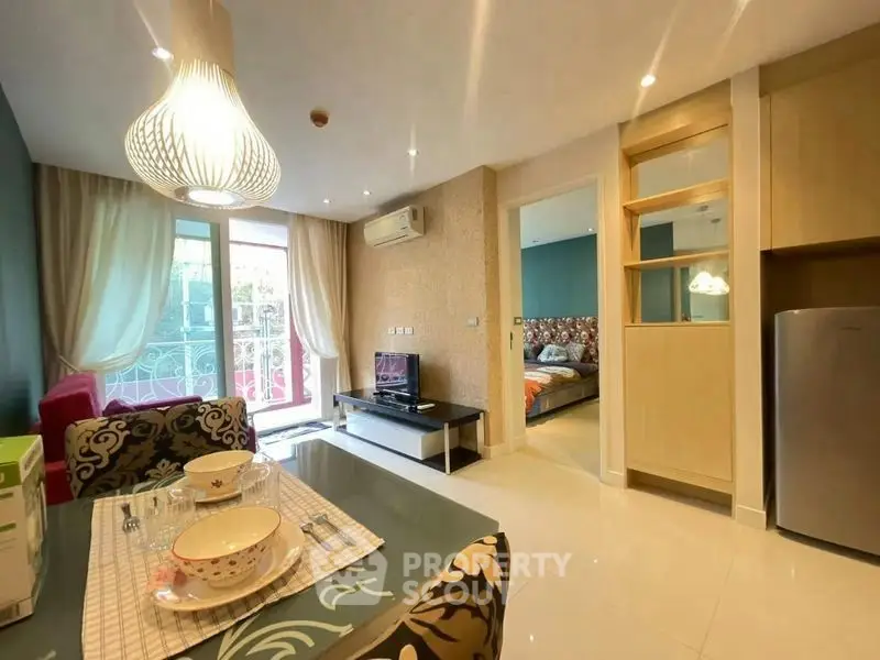 Modern open-plan living room with dining area and balcony access