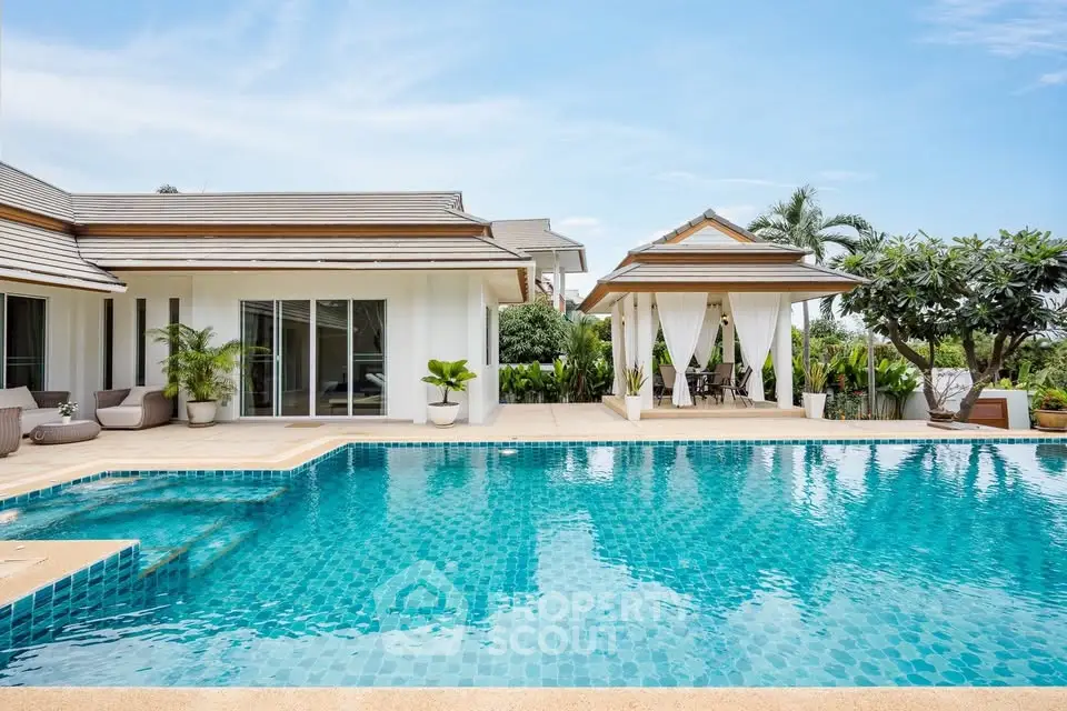 Luxurious villa with stunning pool and lush garden, perfect for tropical living.