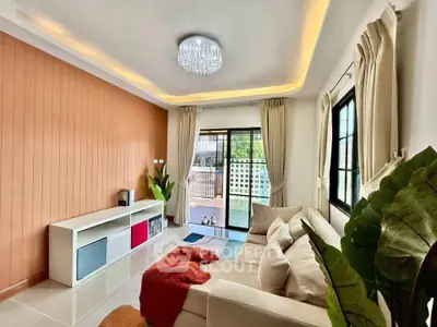 Spacious living room with modern decor and large windows offering ample natural light.
