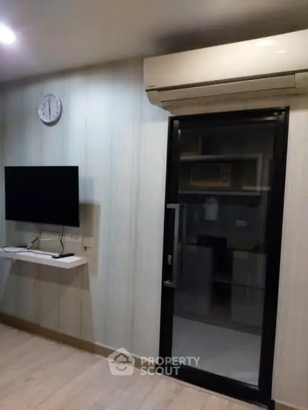 Modern living room with wall-mounted TV and air conditioning