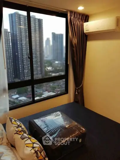 Modern bedroom with city view and air conditioning in high-rise apartment