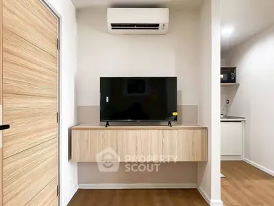 Modern living room with wall-mounted TV and air conditioning unit