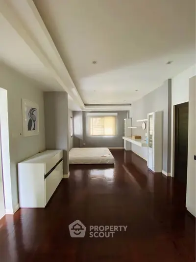 Spacious modern living room with hardwood floors and minimalist decor