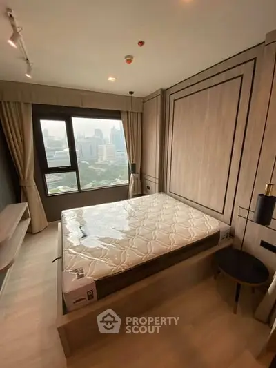 Modern bedroom with city view, featuring a stylish bed and elegant decor, perfect for urban living.