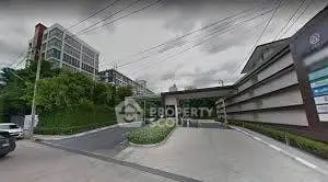 Modern residential building entrance with lush greenery and sleek design