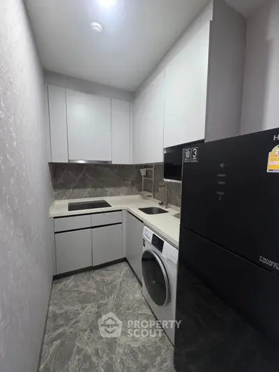 Modern compact kitchen with sleek appliances and stylish cabinetry