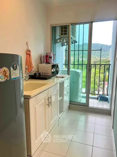 Charming kitchen with balcony view and modern appliances in cozy apartment