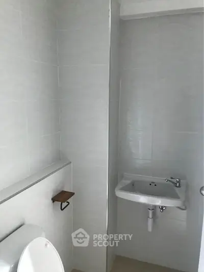 Compact bathroom with modern fixtures and minimalist design