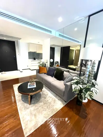 Modern living room with stylish decor and hardwood floors in a contemporary apartment.