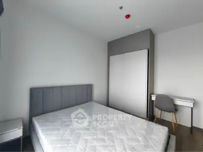 Modern bedroom with sleek design, featuring a comfortable bed and stylish furniture, perfect for relaxation.