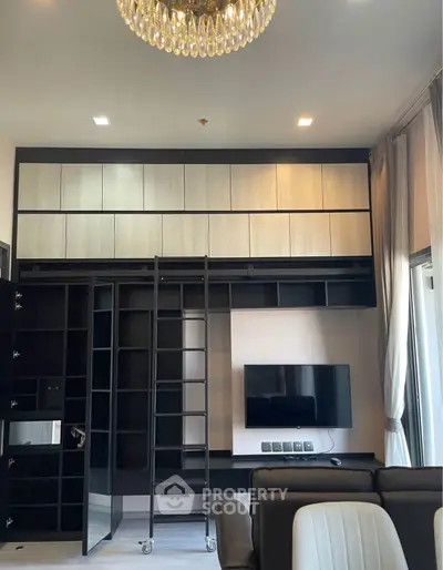 Luxurious living room with modern built-in shelving and elegant chandelier