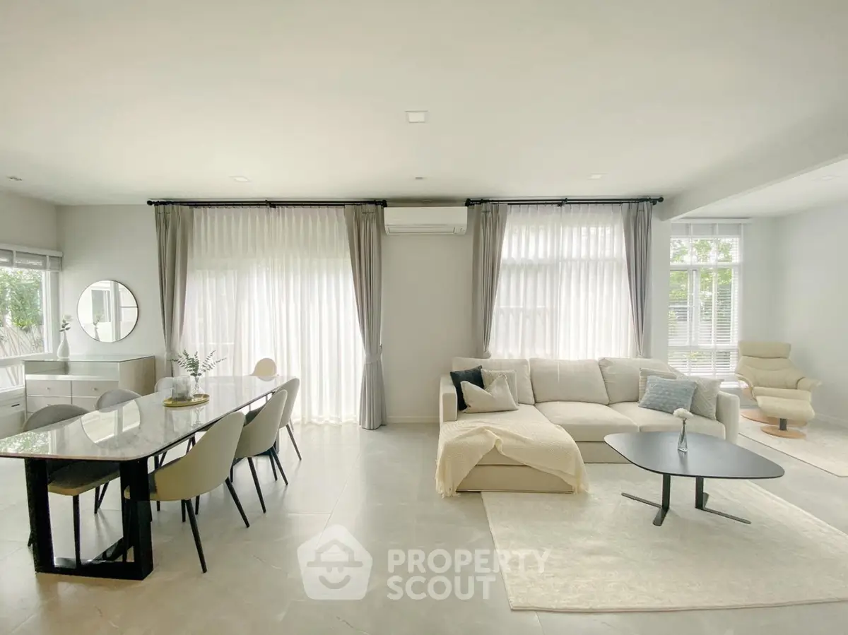 Spacious modern living room with elegant dining area and natural light