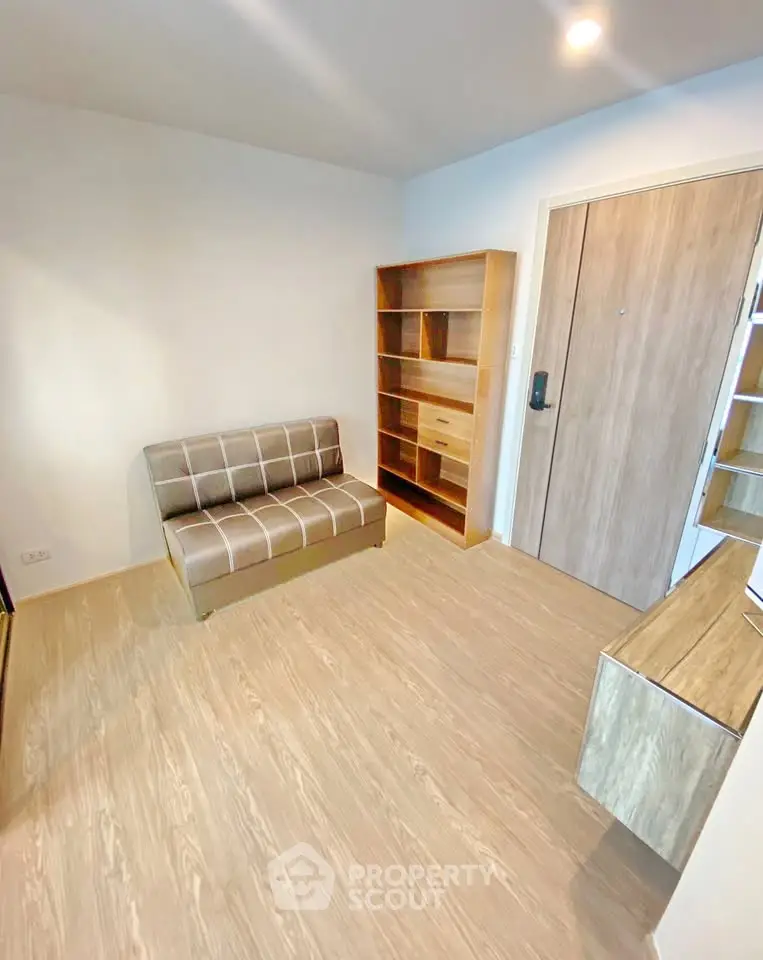 Modern minimalist living room with wooden flooring and sleek furniture